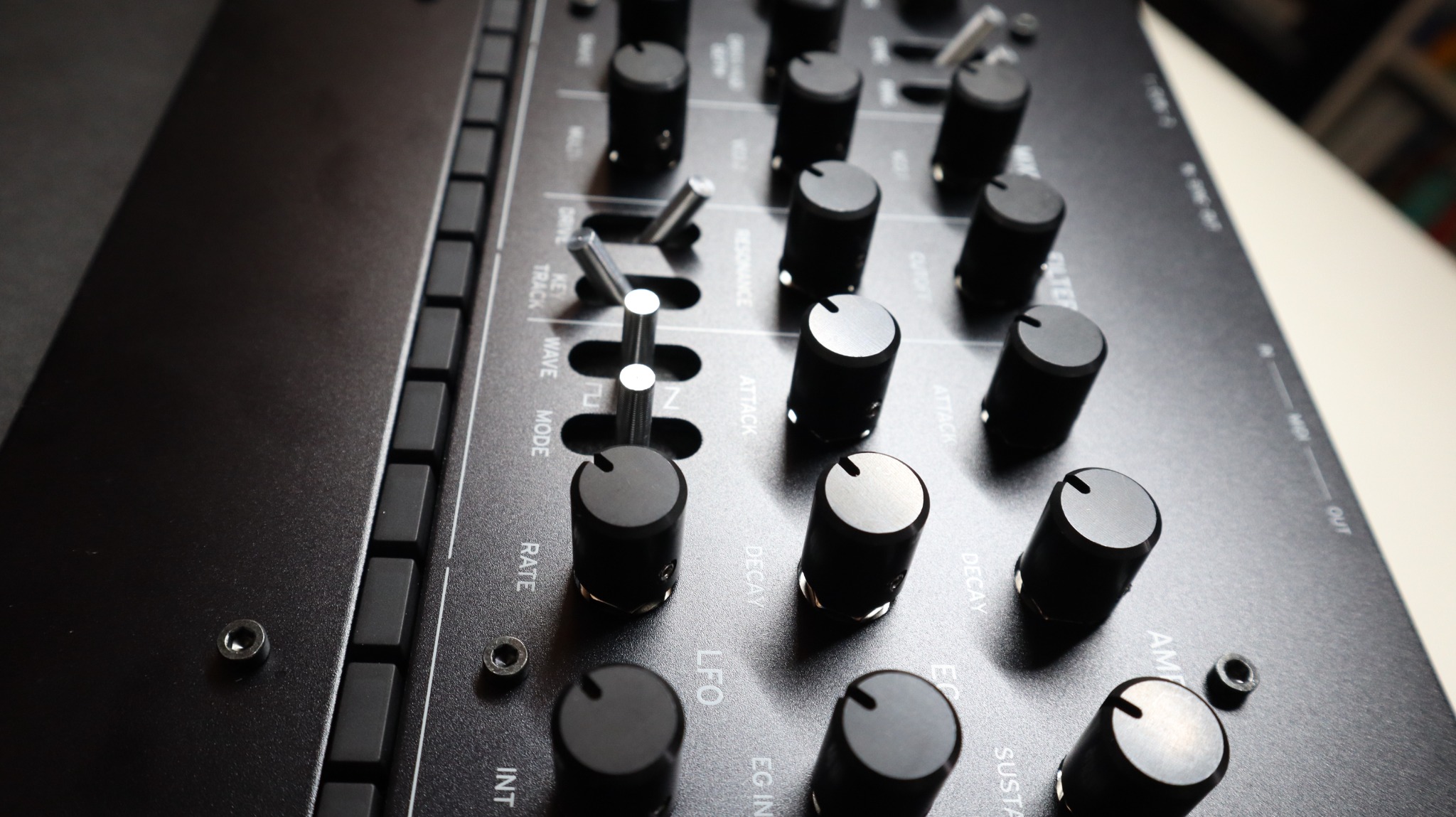 Close-up of replacement knobs installed on a Korg Minilogue panel.