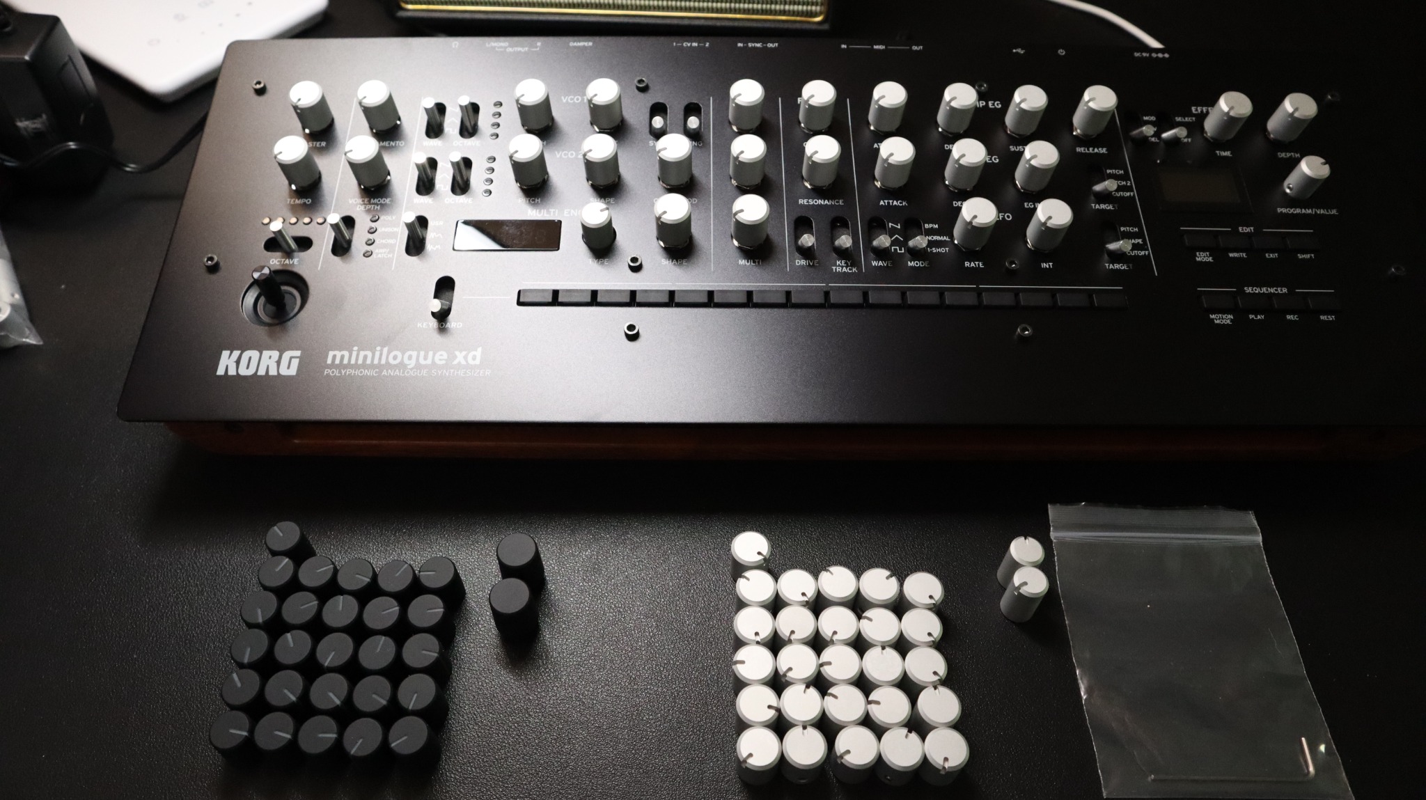Korg Minilogue XD with replacement knob sets shown in front of the instrument.